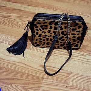 Black leopard hide on hair crossbody bag.